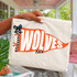 Pennant Teams DTF Heat Transfer, a decorative orange and white flag-shaped design with the word 'WOLVES' and a black ribbon bow, suitable for sports team apparel and accessories.