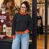 Blank Mockneck Sweatshirt — Preorder | Multiple Colors, woman wearing a black sweatshirt with orange accents standing outside a clothing store.