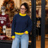 Blank Mockneck Sweatshirt — Preorder | Multiple Colors, navy blue sweatshirt with yellow accents worn by a woman in a store window display.