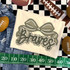Camo Bow School Mascot DTF Heat Transfer, design featuring a camo bow with the word 'Bruins' written in stylized script.