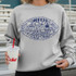 Football Doodle CHOOSE YOUR COLOR DTF Heat Transfer, image of a girl's sweatshirt with a blue football-themed doodle design.