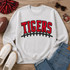 Red Chenille Tigers with Black accents with football laces patch on an ash crewneck