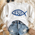 Metallic blue puff heat transfer featuring the Jesus fish symbol with Jesus lettering for Christian apparel, church shirts, and faith-based clothing.