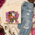 Pink Glitter Mascot - 62 teams - DTF Heat Transfer, laid on a flat surface alongside distressed jeans, sneakers, and accessories.