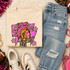 Pink Glitter Mascot - 62 teams - DTF Heat Transfer, colorful graphic pink glitter mascot design on a beige sweatshirt, paired with distressed denim jeans, sneakers, and sports accessories.