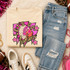 Pink Glitter Mascot - 62 teams - DTF Heat Transfer, pink glitter mascot design on a beige sweatshirt surrounded by casual clothing and accessories.