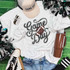 Game Day Sequin Patch With Football, embellished patch on white t-shirt with game day theme, surrounded by cheerleading pom-poms, sneakers, and brown tumbler on green background.