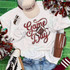 Game Day Sequin Patch With Football, close-up of sports-themed patch with football design and shiny sequins on a white T-shirt, surrounded by cheerleading pom-poms, a baseball cap, sneakers, jeans, and a tumbler.