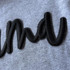 Mama Puff Embroidery Patch, a black embroidered patch featuring the word 'Mama' in a stylish, cursive font on a gray fabric background.