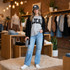 Black LOCAL fluffy varsity letter patch applied to a gray T-shirt styled with a black cardigan and jeans