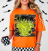 Retro Monster Halloween DTF Transfer, colorful neon-style star and monster face design on an orange T-shirt.