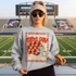 Game Day Polka Dot Helmet DTF Transfers | Football Color Combo Collection, girl wearing a sweatshirt with football-themed design at stadium