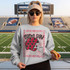 Game Day Polka Dot Helmet DTF Transfers | Football Color Combo Collection, girl wearing a sweatshirt with football themed design in a stadium.