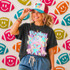 Neon Star Mascot DTF Transfers | School Spirit Mascot Collection, vibrant neon-themed design featuring a girl wearing a graphic t-shirt and a cap with the phrase 'Game Day', with background of colorful football-shaped plush toys.