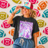 Neon Star Mascot DTF Transfers | School Spirit Mascot Collection, colorful neon star-themed design on a t-shirt worn by a smiling woman with a vibrant sports-themed background.