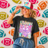 Neon Star Mascot DTF Transfers | School Spirit Mascot Collection, vibrant colorful mascot design with neon stars and a fierce tiger illustration on a black T-shirt worn by a smiling woman.
