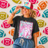 Neon Star Mascot DTF Transfers | School Spirit Mascot Collection, vibrant neon star designs on a black t-shirt worn by a smiling woman, colorful football-themed wall background.