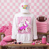 Loud & Proud Mascot DTF Transfers | Retro School Spirit Mascot Collection with a white sweatshirt featuring a pink and purple wolf design and the words 'LOUD and Proud', in a themed pink and white decor setting with a football, pink accessories, and folded pink towels.