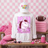 Loud & Proud Mascot DTF Transfers | Retro School Spirit Mascot Collection, featuring a white sweatshirt with a pink cartoon horse design and the words 'LOUD & Proud', placed in a themed room with pink checkered background, football, pink accessories, and decorations.