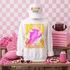 Loud & Proud Mascot DTF Transfers | Retro School Spirit Mascot Collection, vibrant pink and yellow graphic t-shirt with a cartoon lion mascot and bold lettering, displayed on a mannequin with a white cap, surrounded by pink sports-themed accessories in a colorful sports-themed setting.