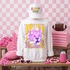 Loud & Proud Mascot DTF Transfers | Retro School Spirit Mascot Collection, white sweatshirt with a colorful lion mascot and text, cap with 'game day' embroidery, and pink themed sports accessories on a pink checkered background.