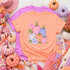 Pastel Pumpkin Patch DTF Transfer, boho fall floral pumpkins design printed on peach and lavender T-shirts surrounded by fall-themed decor including mini pumpkin decorations, knitted scarves, and vibrant flowers for autumn fashion.
