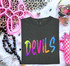 Devils mascot DTF transfer in bright neon watercolor brush lettering with paint splatter accents