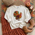 Thanksgiving Turkey Sequin Patch, a sparkly appliqué featuring a colorful turkey with vibrant feathers on a white sweatshirt.