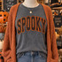 SPOOKY orange polka dot corduroy appliqué patch with black embroidered edging shown on charcoal pepper shirt