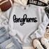 Black Longhorns fluffy heat press appliqué patch with script lettering displayed on a light gray sweatshirt.