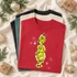 Sly green holiday character DTF transfer with snowy fur texture and pink and blue star sparkles on a red shirt
