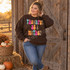 Thankful As A Mother DTF transfer in retro bubble lettering with brown line-art pumpkins on a beige shirt Shown on a Dark Chocolate crewneck sweatshirt.