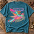 Rather Be Hunting DTF transfer with a colorful patchwork-patterned bird in striped, polka dot, star, and zebra print designs, bold varsity lettering, and scattered stars Shown on a Lagoon t-shirt.