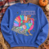 Rather Be Hunting patchwork turkey DTF transfer with colorful fall-print tail feathers and black star accents Shown on a Heather Deep Royal crewneck sweatshirt.