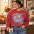 Turkey Day DTF transfer with colorful patchwork-patterned turkey and matching patterned bubble letters Shown on a Heather Scarlet Red crewneck sweatshirt.