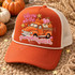 Take Me To The Pumpkin Patch DTF transfer with vintage orange truck hauling pink, orange, and cream pumpkins in a plush embroidery-look patch style Shown on a rust orange foam front, ivory mesh back, cream rope trucker hat.