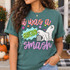It Was a Graveyard Smash Halloween DTF transfer with two cartoon ghosts, a crypt, colorful stars, and bold patterned lettering Shown on a Island Green t-shirt.