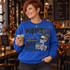 Mombie skeleton mom DTF transfer with heart sunglasses, floral bun, iced coffee, spiderweb, and dripping horror lettering reading Mombie like a regular mom but without coffee Shown on a Royal crewneck sweatshirt.