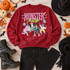Monster Mash Halloween DTF transfer with retro lettering and dancing mummy, Dracula, Frankenstein's monster, and werewolf characters with bats and starburst doodles Shown on a Cherry Red crewneck sweatshirt.