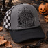 Mysterious & Spooky gothic Victorian mansion DTF transfer with crescent moon, bats, and wrought-iron gate in black ink illustration style Shown on a Charcoal front panel, black bill, black-and-white checkered mesh trucker hat.