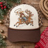 Cowboy swinging a lasso while riding Rudolick the reindeer DTF transfer, featuring western gear, studded saddle, and jingle-bell collar in illustrated style Shown on a Ivory front panel, chocolate brown bill, leopard print mesh back trucker hat.