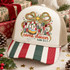Love Came Down nativity DTF transfer with patchwork-style LOVE lettering, baby Jesus in a manger, a red green and gold ribbon bow, starburst, and Luke 2:11 scripture citation Shown on a ivory front panel, red and green striped bill, khaki mesh back trucker hat.