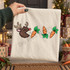 Pac-Man style cartoon reindeer head with antlers and red nose chasing a trail of carrots DTF transfer on Christmas shirt Shown on a Ivory t-shirt.