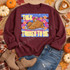 Talk Turkey To Me Thanksgiving DTF transfer with cartoon roasted turkey chatting on a retro telephone, surrounded by orange stars on a blue starred background Shown on a Maroon crewneck sweatshirt.
