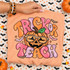 Trick or Teach Halloween DTF transfer with jack-o-lantern wearing leopard-print sunglasses, bats, and puffy bubble lettering Shown on a Peachy t-shirt.