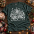 Who-Ville Christmas DTF transfer with white linework snowy village, decorated tree, crescent moon, stars, and the phrase 'where Christmas means a bit more' in cursive lettering Shown on a Blue Spruce t-shirt.