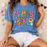 Mama's Girl DTF transfer with oversized mixed-pattern lettering, rainbow, daisies, stars, clouds, and smiley face doodles Shown on a China Blue t-shirt.