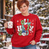 Jolly Happy Soul bubble-letter Christmas DTF transfer with snowflakes and a smiling snowman in a blue top hat holding a pipe Shown on a Cherry Red crewneck sweatshirt.