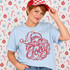 Jolly Santa Claus face DTF transfer in red sequin-inspired line art with 'Jolly' script lettering across his beard Shown on a Ice Blue t-shirt.