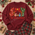 Joy to the World nativity DTF transfer with crochet-textured JOY lettering, red bow, gold star, and manger scene Shown on a Maroon crewneck sweatshirt.